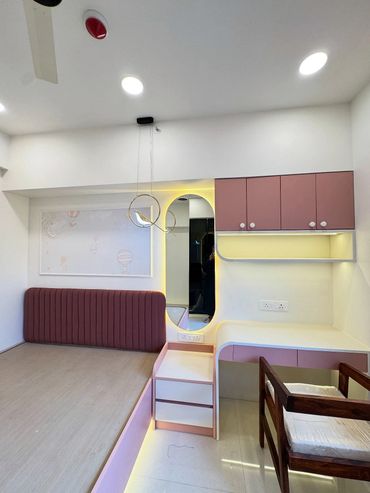 Modern minimalist bedroom with pink accents and built-in furniture.