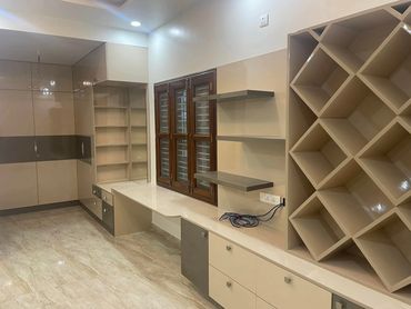 Modern beige and gray kitchen with ample storage and shelving.