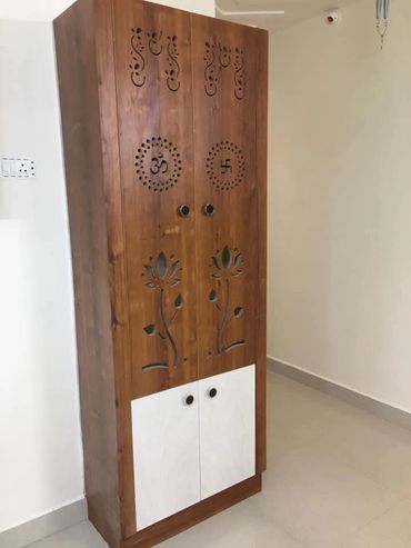 Wooden cabinet with carved religious symbols and floral designs.