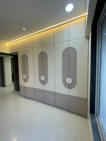 Modern hallway with sleek built-in storage cabinets and ambient lighting.