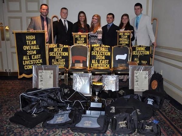 Group photo with livestock competition awards and banners from 2014