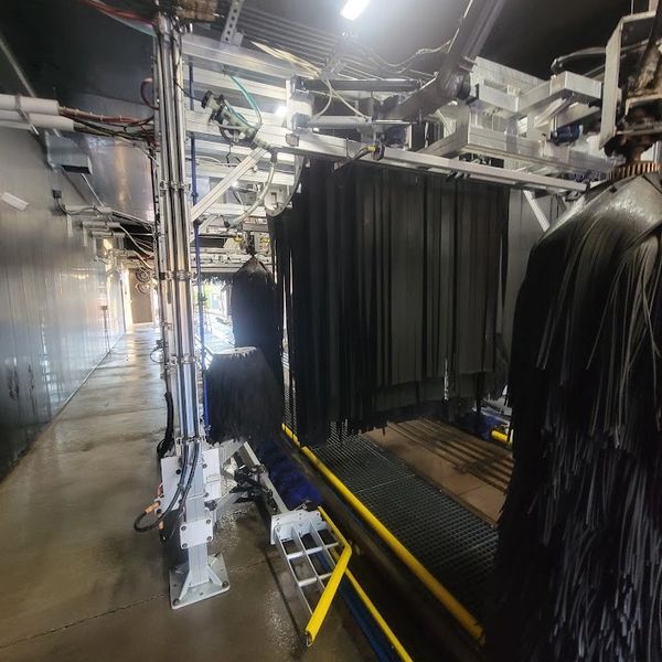 Interior view (before and after) of an automated conveyor car wash tunnel system.