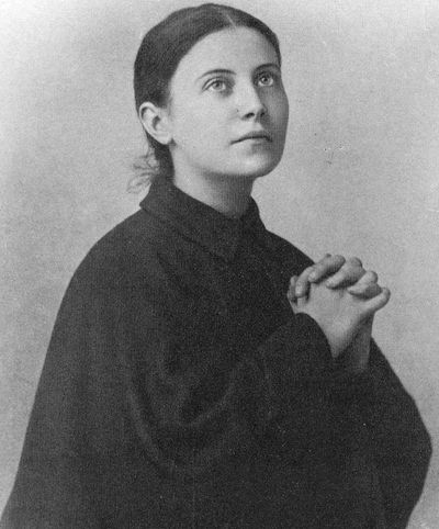 Black and white photo of St. Gemma praying with clasped hands.