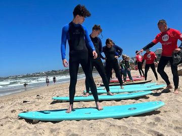 Ride the Waves with Us: Expert Surfing Lessons at Your Beach Front Getaway!