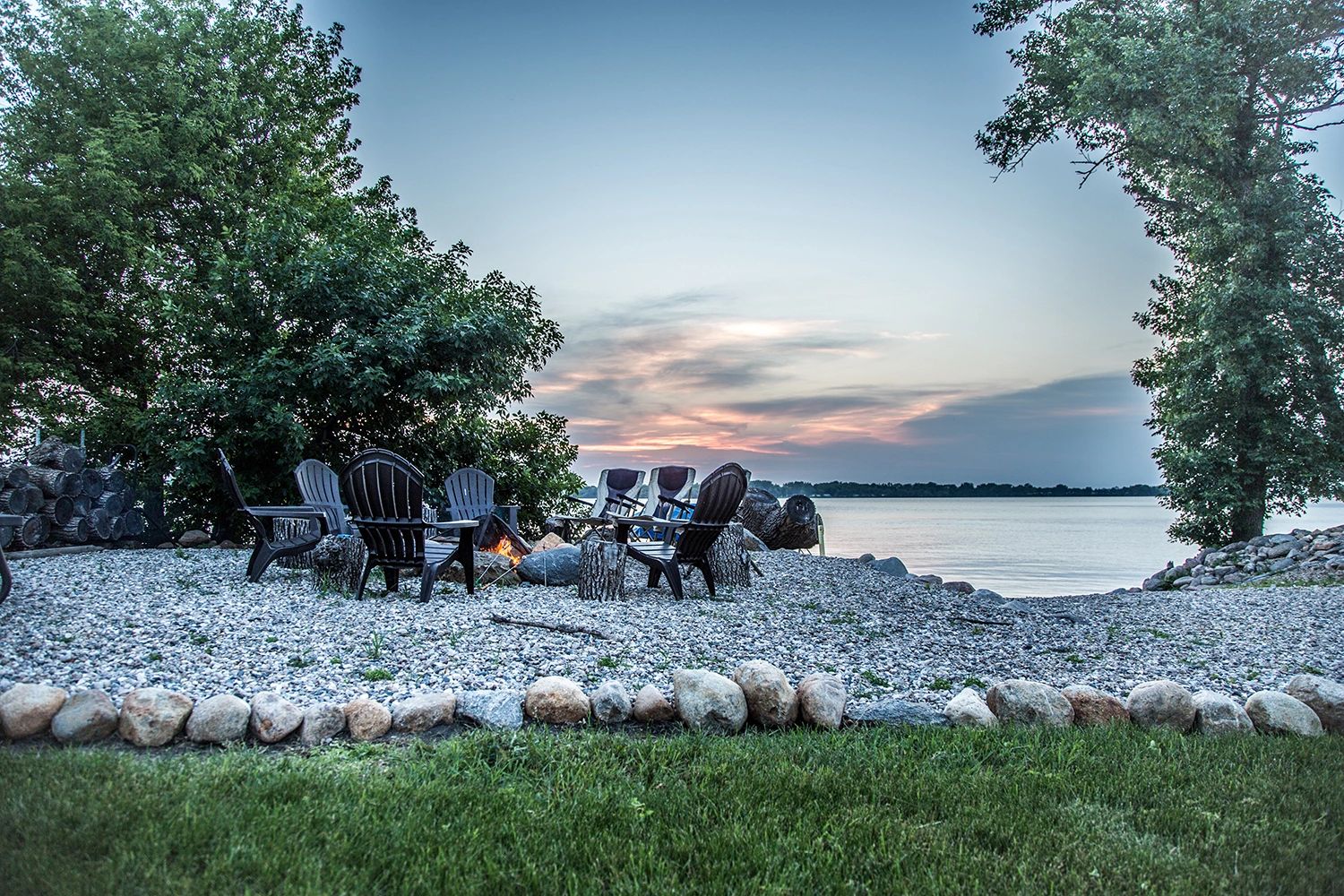 A Firepit And Adirondack Chairs In Front Of Lake Benton Minnesota