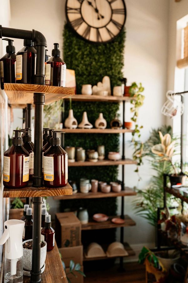 Shelves with skincare products and handmade pottery available for purchase at the spa