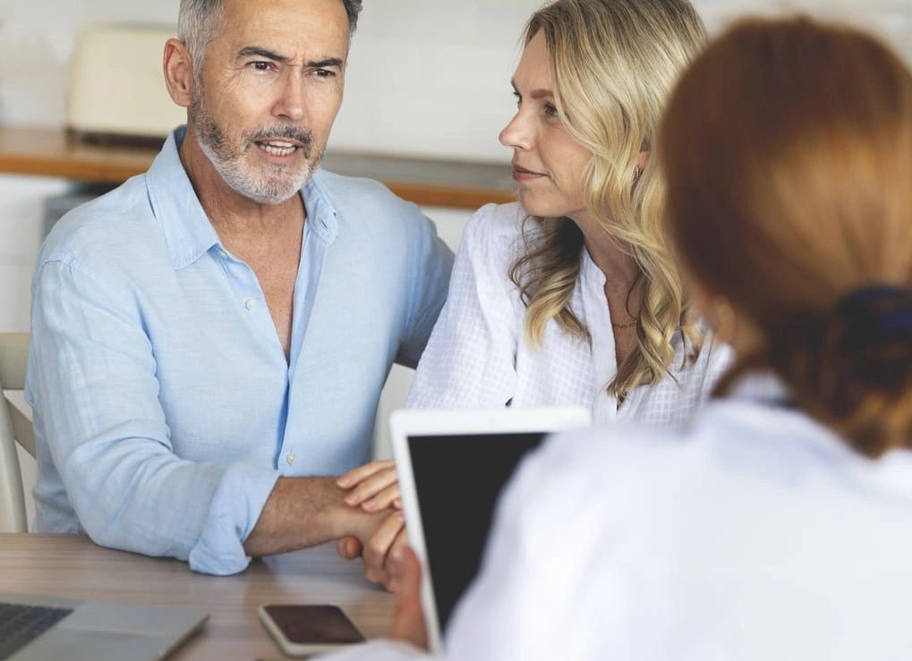Canadian couple discussing private healthcare options with an advisor