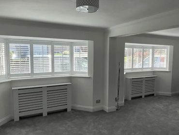 2 5 sided bays with full height white shutters