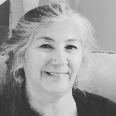 A head shot of Sue Schmidt in black and white
