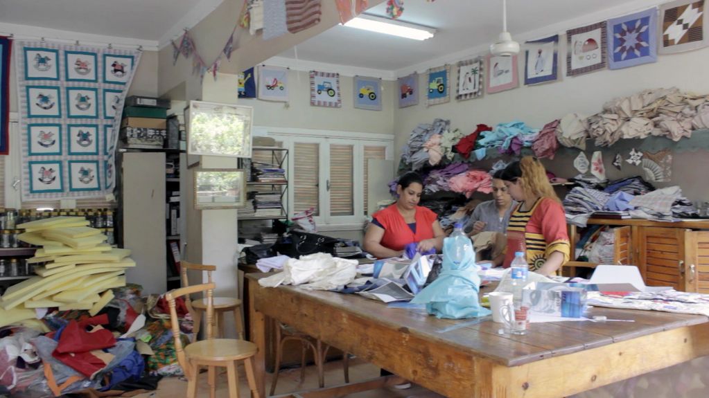 Women learning basics of sewing.