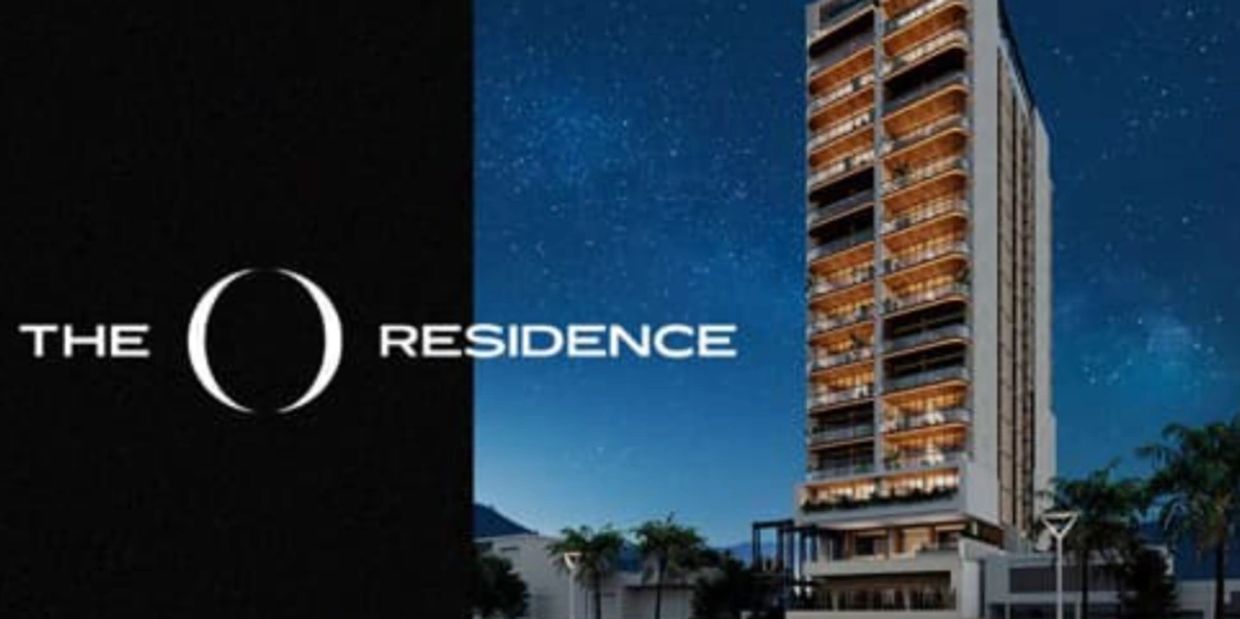 The O Residence building at night with illuminated balconies.