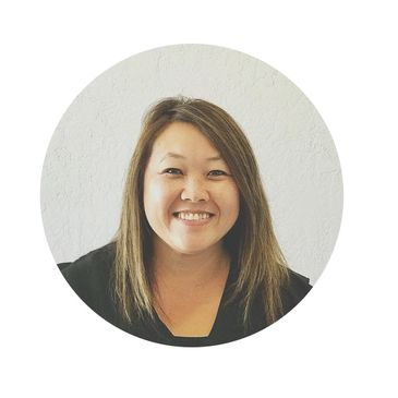 Smiling woman with straight hair against a plain white background.