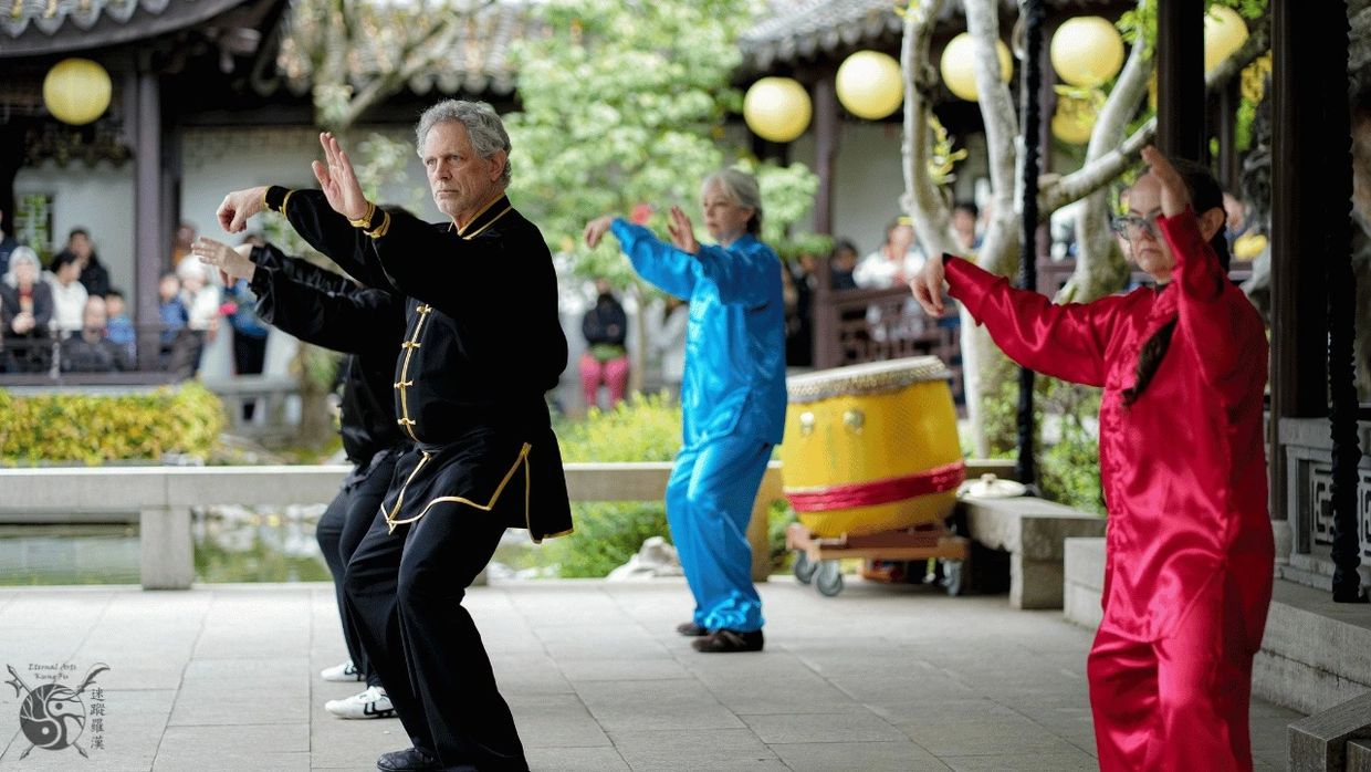4 people on stage doing Tai Chi led by Sifu Eric M Emert