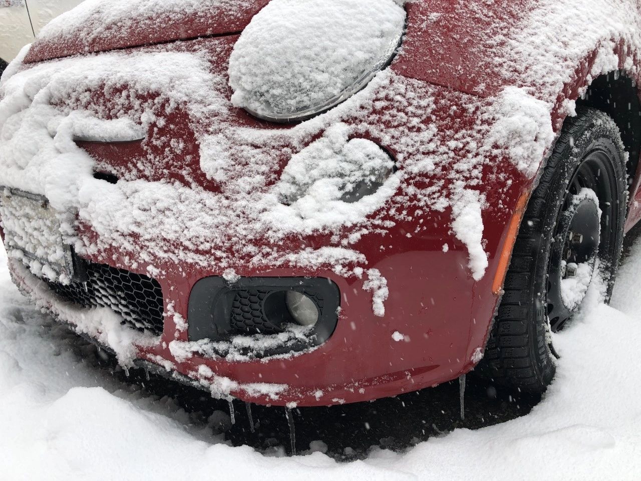 red car remote starter covered in snow