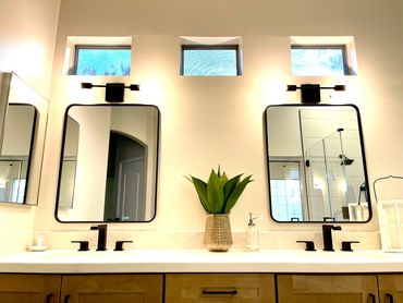bathroom with two separate mirrors and faucet installed