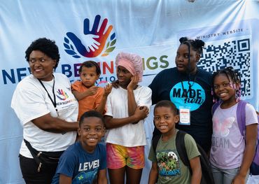 Group photo at a community event with kids and adults.