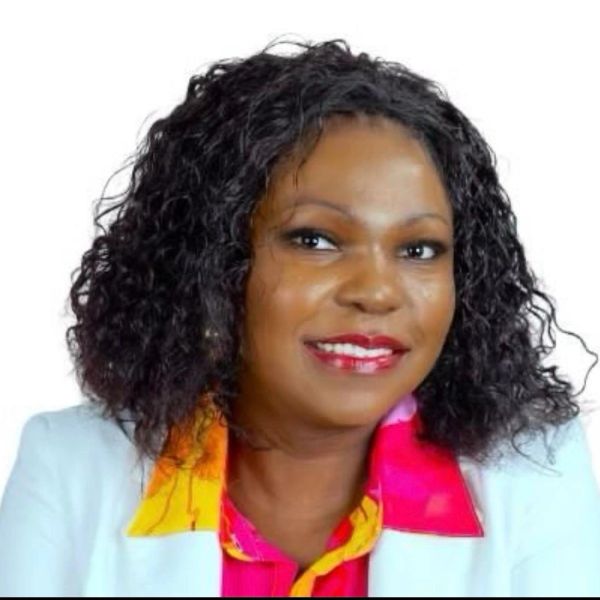 Smiling woman with curly hair and bright lipstick.