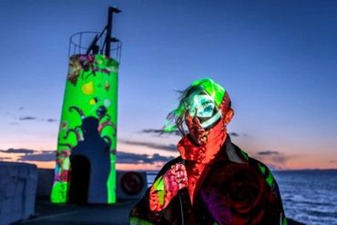 coloured lights on the face of a person