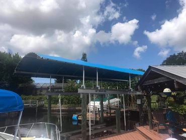 Coastline Boatlift Cover installed next to boat house