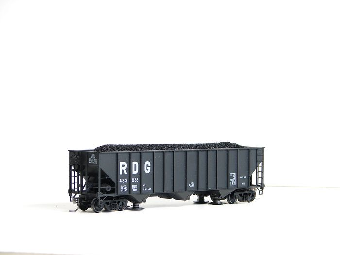 Black freight train coal hopper car labeled RDG on white background.