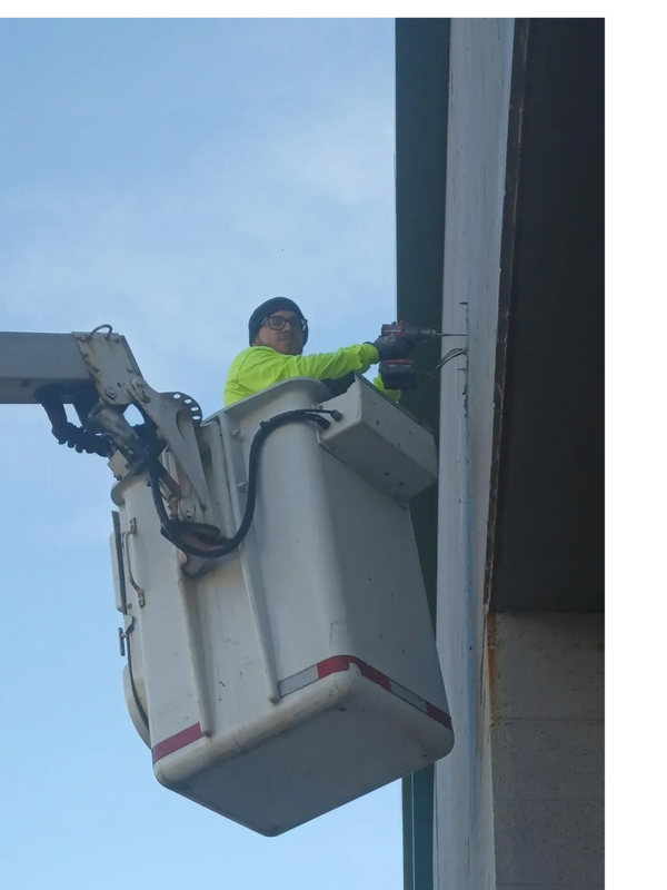 Electrician in service bucket