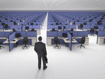 Man standing in front of a row of desks