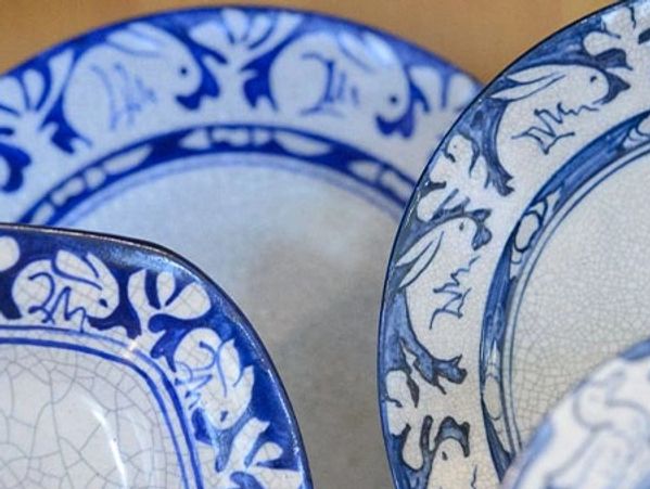 Close-up of blue and white patterned ceramic plates with intricate designs.