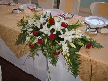 white lily and red rose top table wedding arrangement by Arabella's flowers