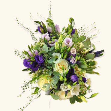 Hand tied bridal bouquet made up of white roses, lilac lisianthus and purple veronica.