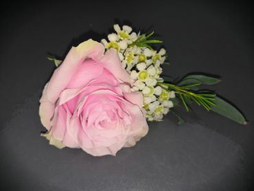 Pink rose and wax flower button hole