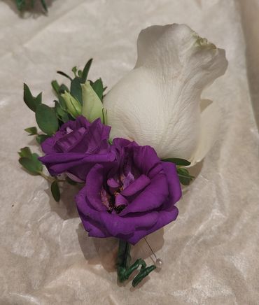 White rose and purple lizzy button hole 