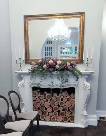 pink rose wedding arrangement on fireplace by Arabella's flowers