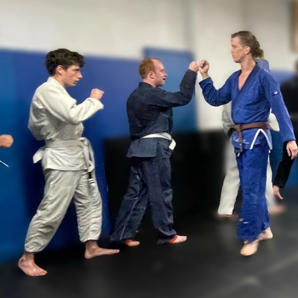a coach leads the end of class fist bumps to other teammates to congratulate them on class