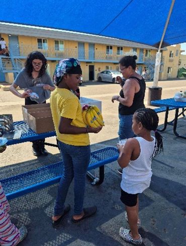 Volunteer helping kids with supplies.