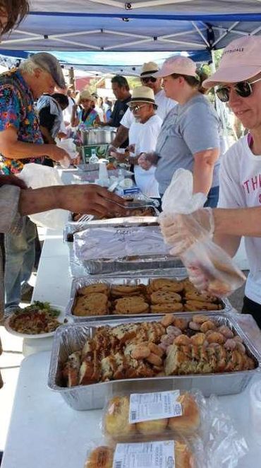 Volunteers serving hot meals.