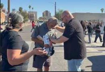 Group of men talking at an event.