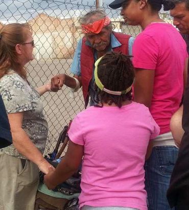 Group of men and women talking at an event.