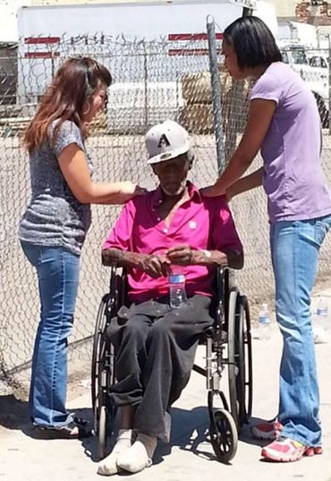 olunteer assisting woman in wheelchair.