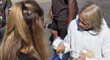 Woman holding a large box of groceries.