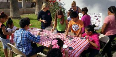 Volunteer and child with a food box.