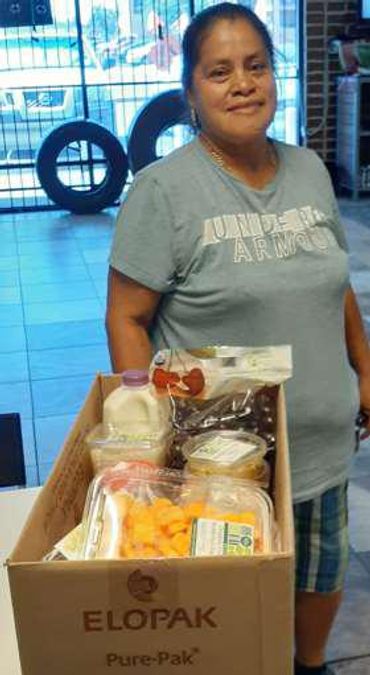Woman holding a box of groceries