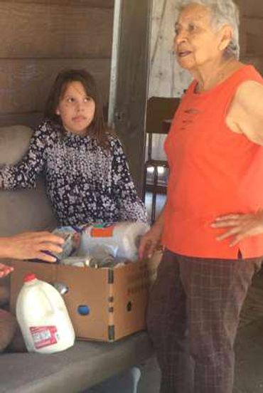 Family receiving boxes of food.