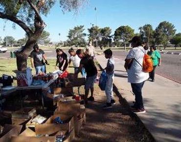 Two women organizing donation items.