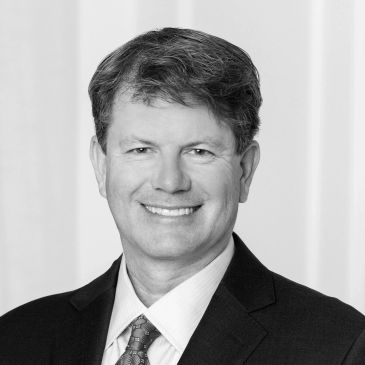 Smiling man in a suit and tie.