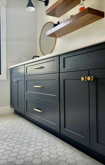 Modern coastal bathroom, gray tile floor, navy blue vanity