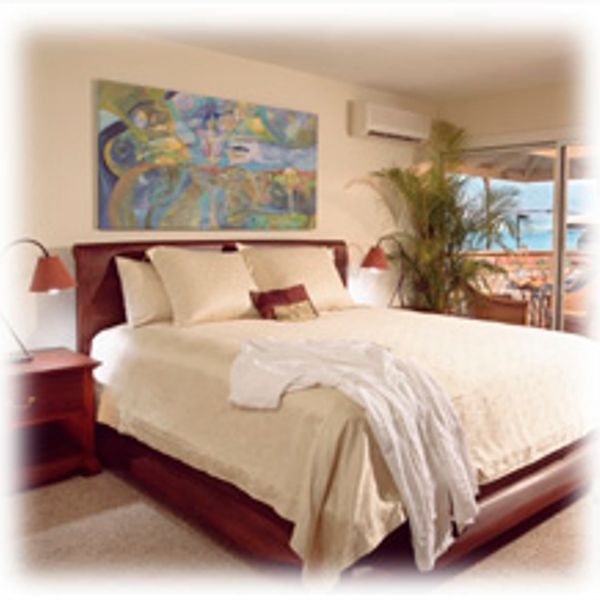 Cozy bedroom with a large bed, soft lighting, and a balcony view.
