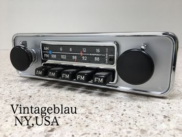 Vintage car radio with AM and FM dials on a speckled countertop.