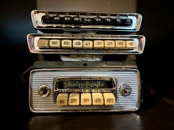 Three vintage Blaupunkt car radios stacked together.