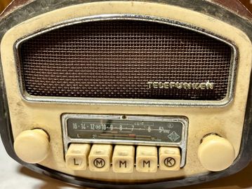 Close-up of a vintage Telefunken radio with tuning knobs and buttons.