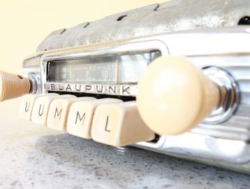 Close-up of a vintage Blaupunkt car radio with beige buttons.